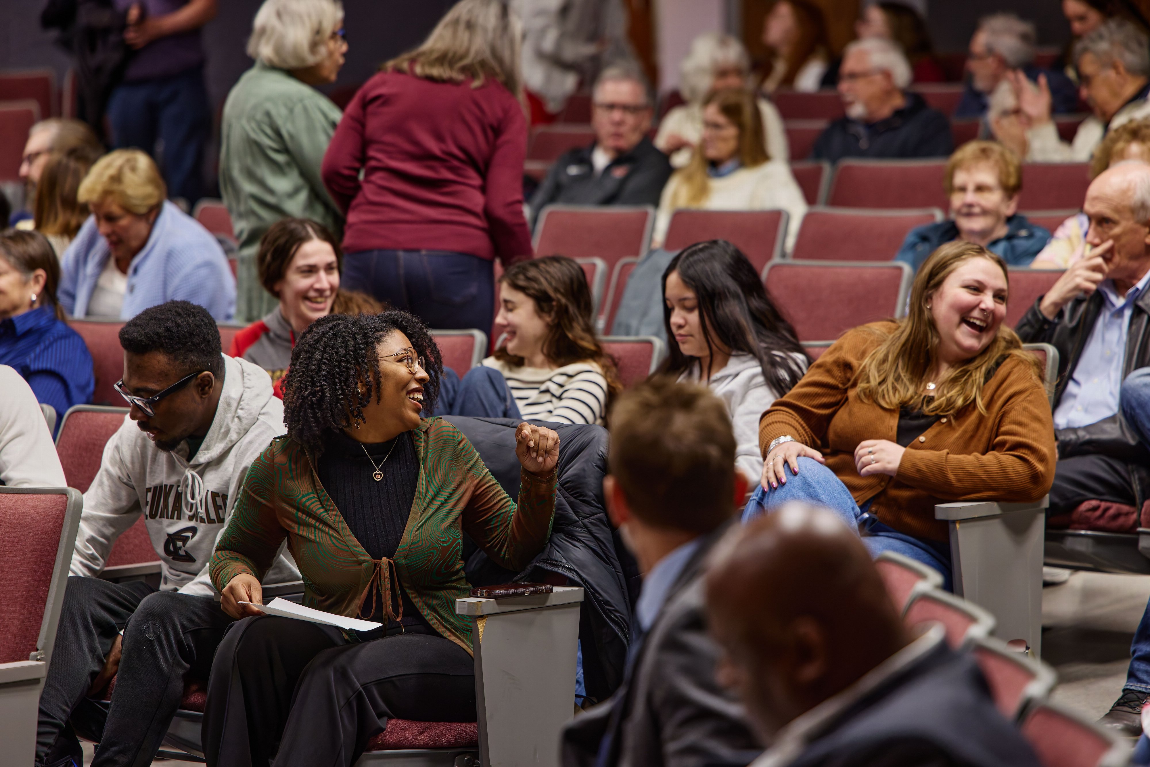 Guests seated in the auditorium laughing during a Reagan Society event