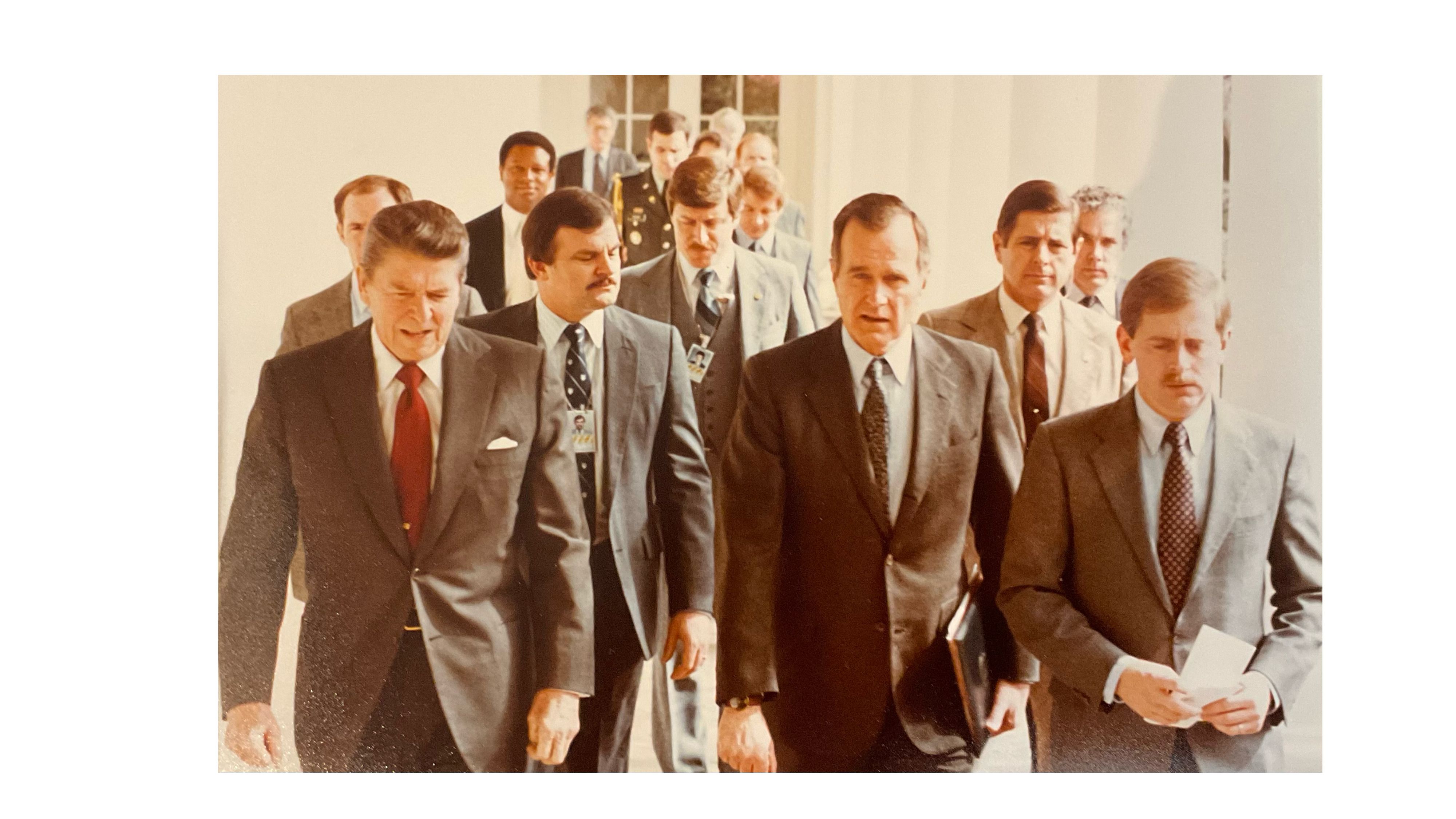 Ambassador Rhodes behind President Reagan and Vice President Bush