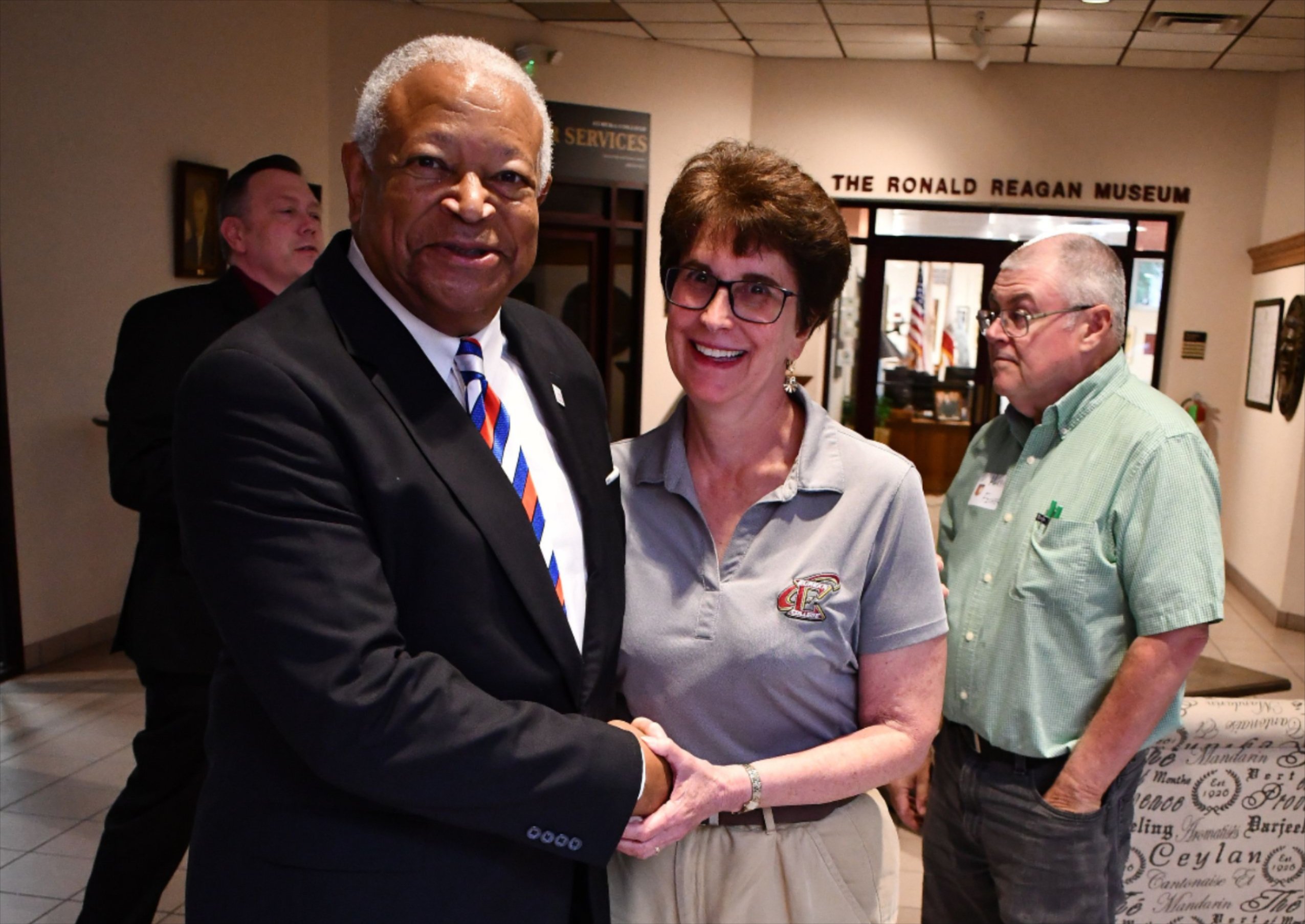 Ambassador Rhodes shaking hands with attendees